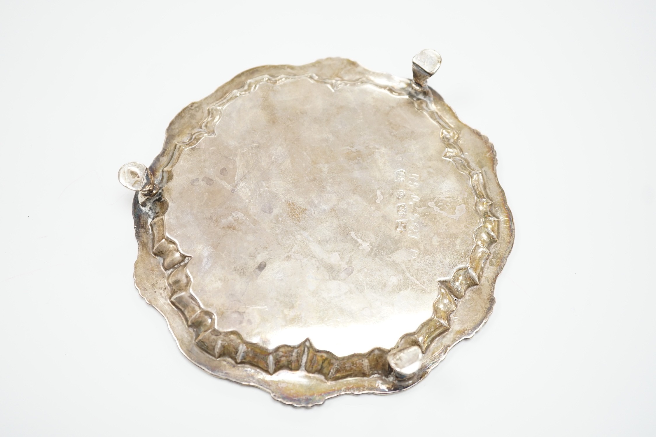 A George II silver waiter, William Peaston, London, 1745, with shell, scroll border, on three hoof feet, 16.7cm, 8.2oz.